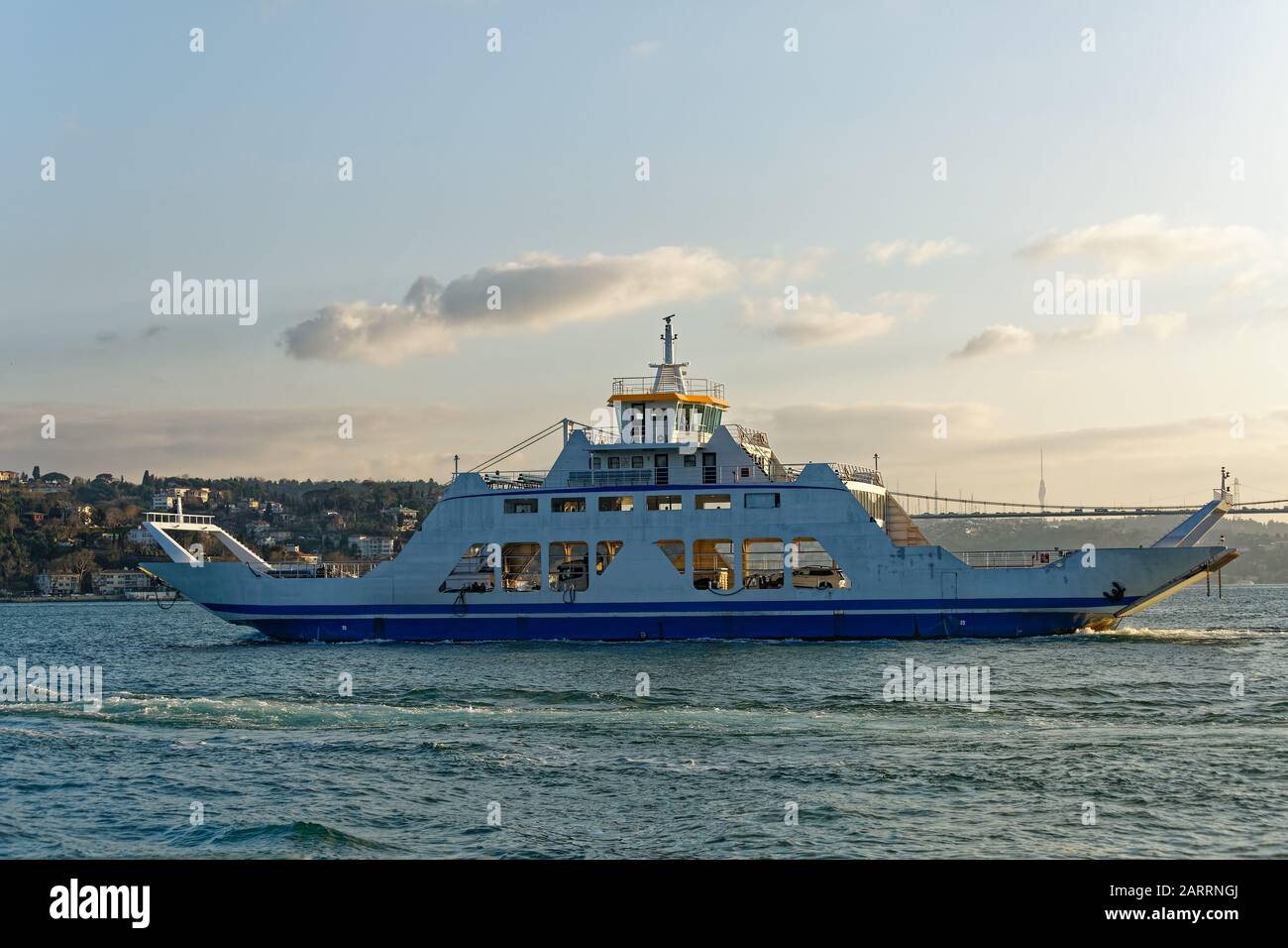 Ferryboat loaded with cars sails through Bosphorus Strait between Marmara and Black Sea in Istanbul / Turkey. Stock Photo