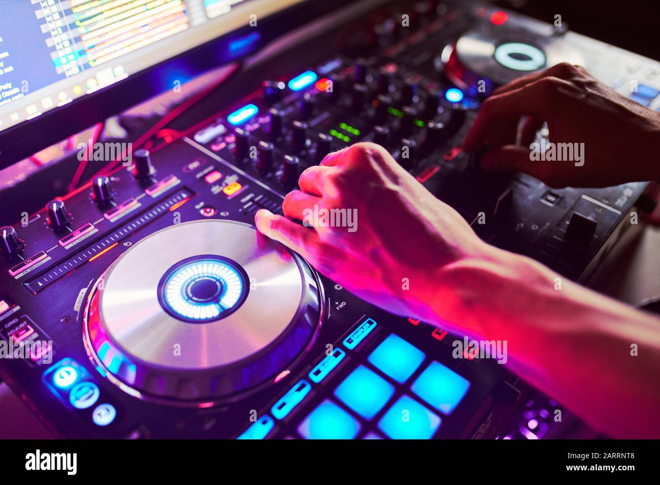 Dj mixes the track in the at a party Stock Photo Alamy