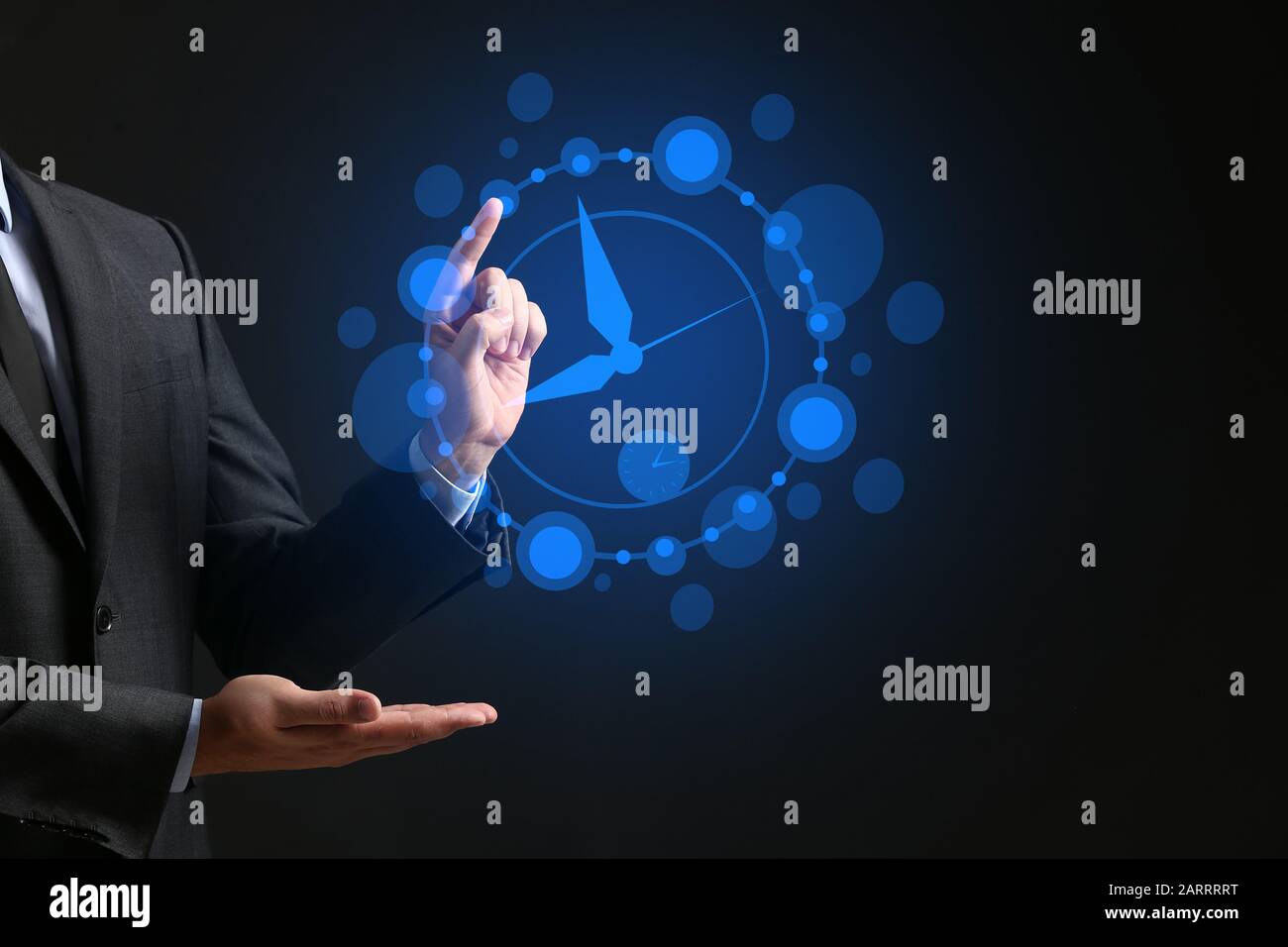 Businessman with drawn clock against dark background Stock Photo