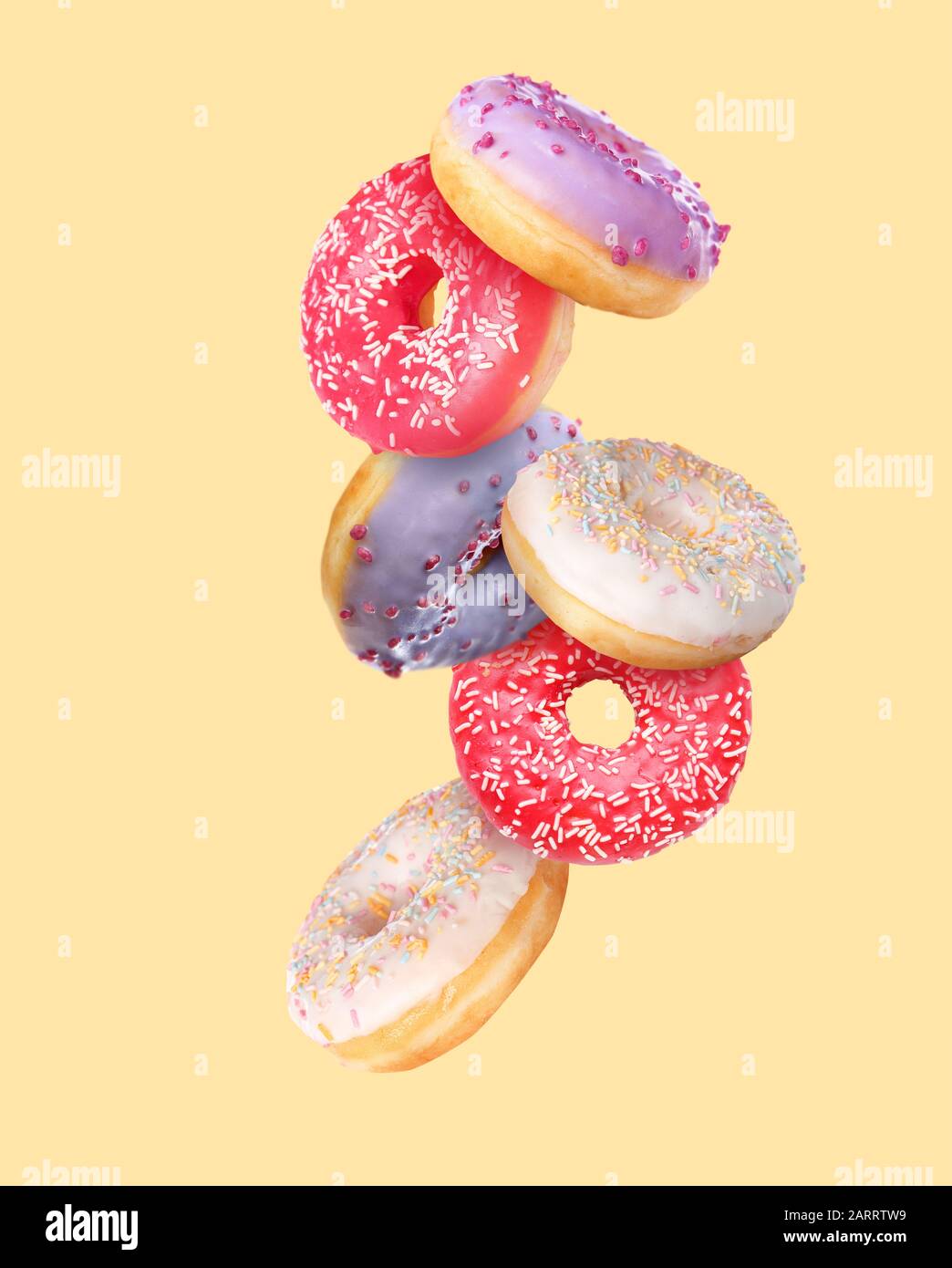 Sweet flying donuts on color background Stock Photo