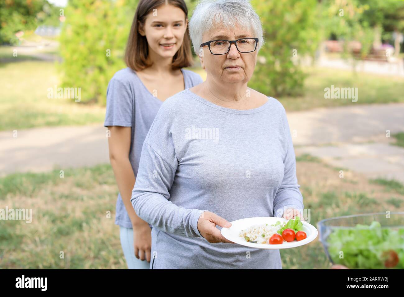 Poor people receiving food from volunteers Stock Photo