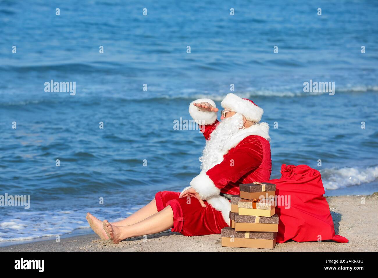 Santa Claus with gifts at sea resort Stock Photo - Alamy