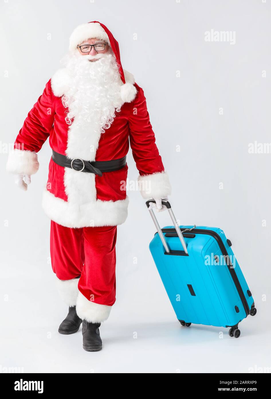 Santa Claus with luggage on white background Stock Photo - Alamy