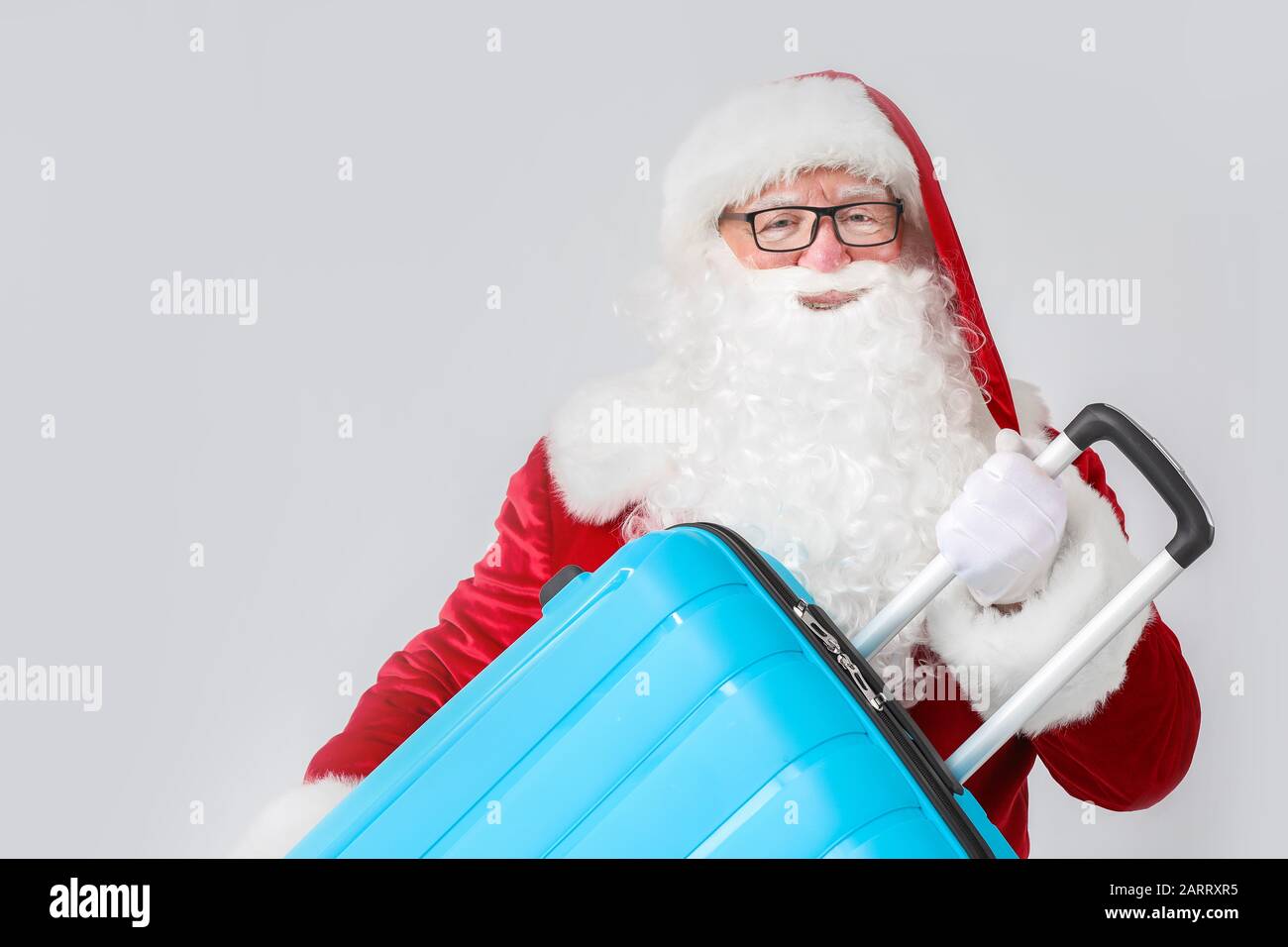 Santa Claus with luggage on white background Stock Photo - Alamy