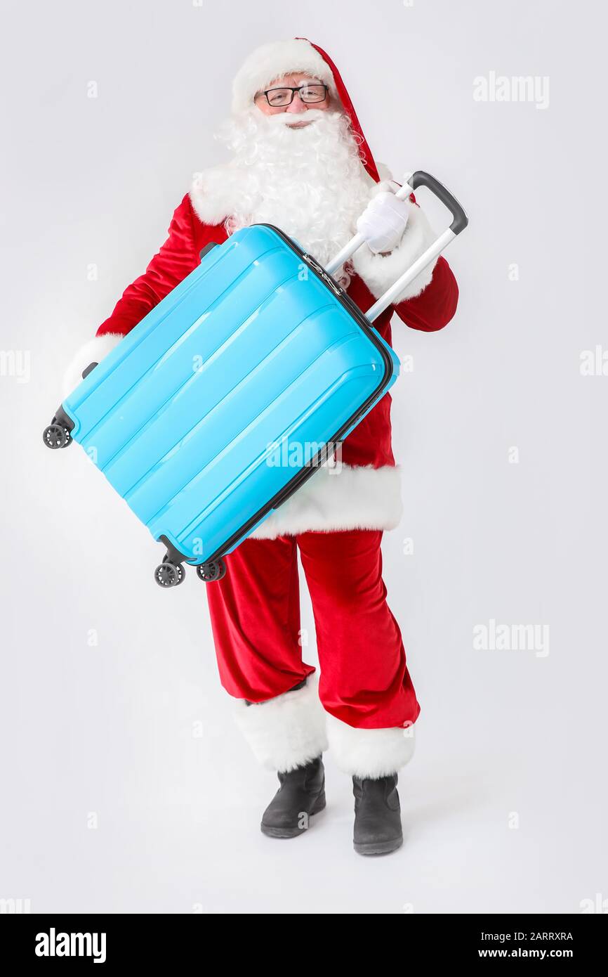 Santa Claus with luggage on white background Stock Photo - Alamy