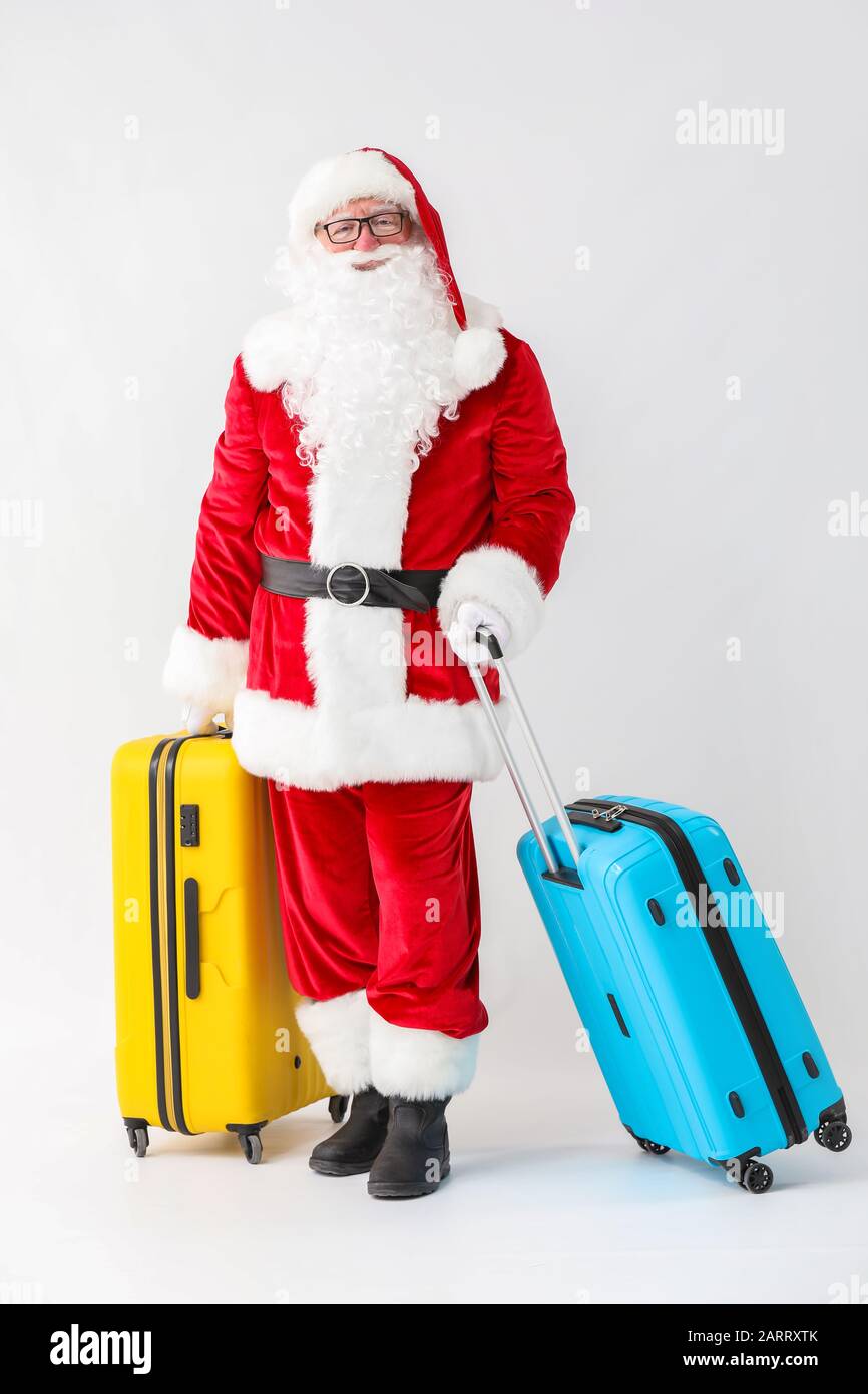 Santa Claus with luggage on white background Stock Photo - Alamy