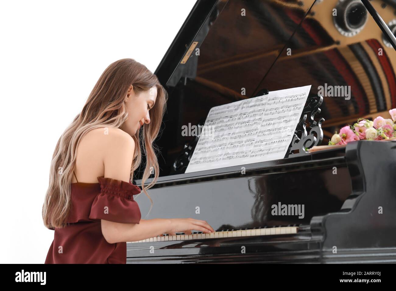 Young woman playing grand piano at the concert Stock Photo - Alamy