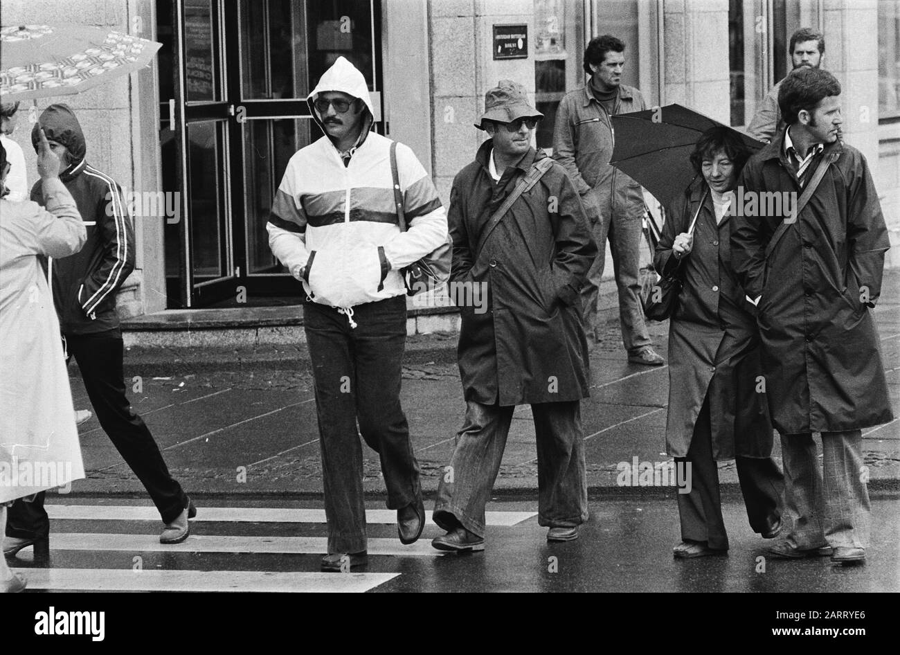 Bad weather in the Netherlands (Amsterdam); people in rainwear Date