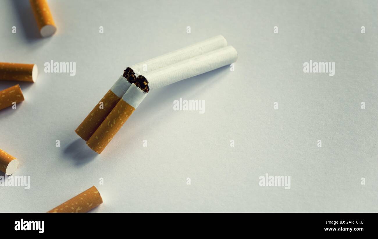 how to shotgun a cigarette Double barrel shotgun made out of two cigarettes quit smoking concept bad  habits Stock Photo