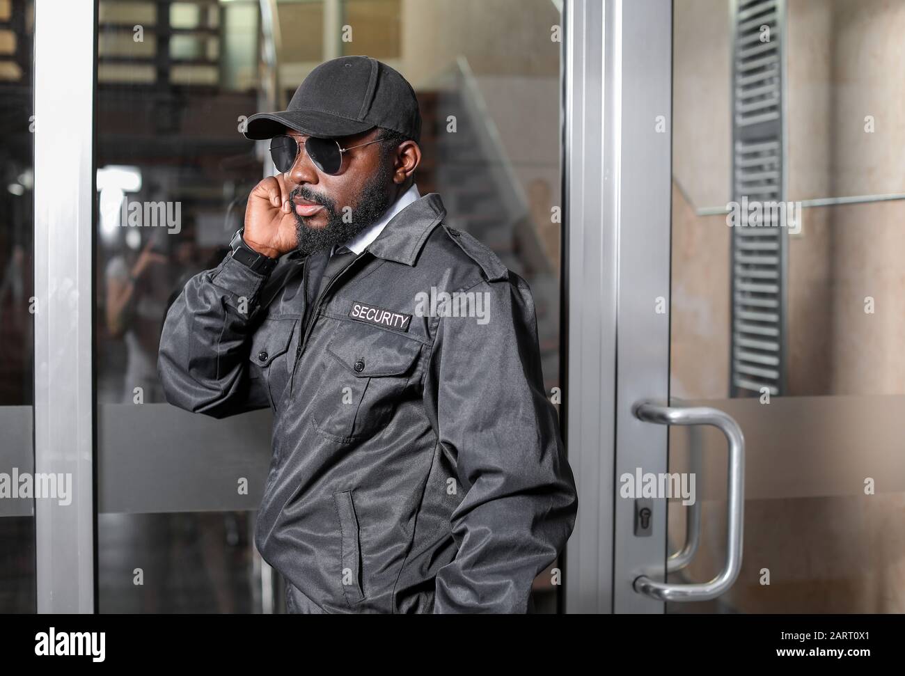 African-American security guard working in building Stock Photo - Alamy