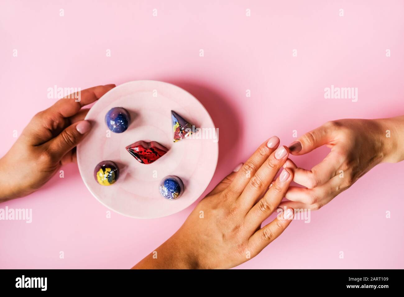 Hands and chocolates Stock Photo Alamy
