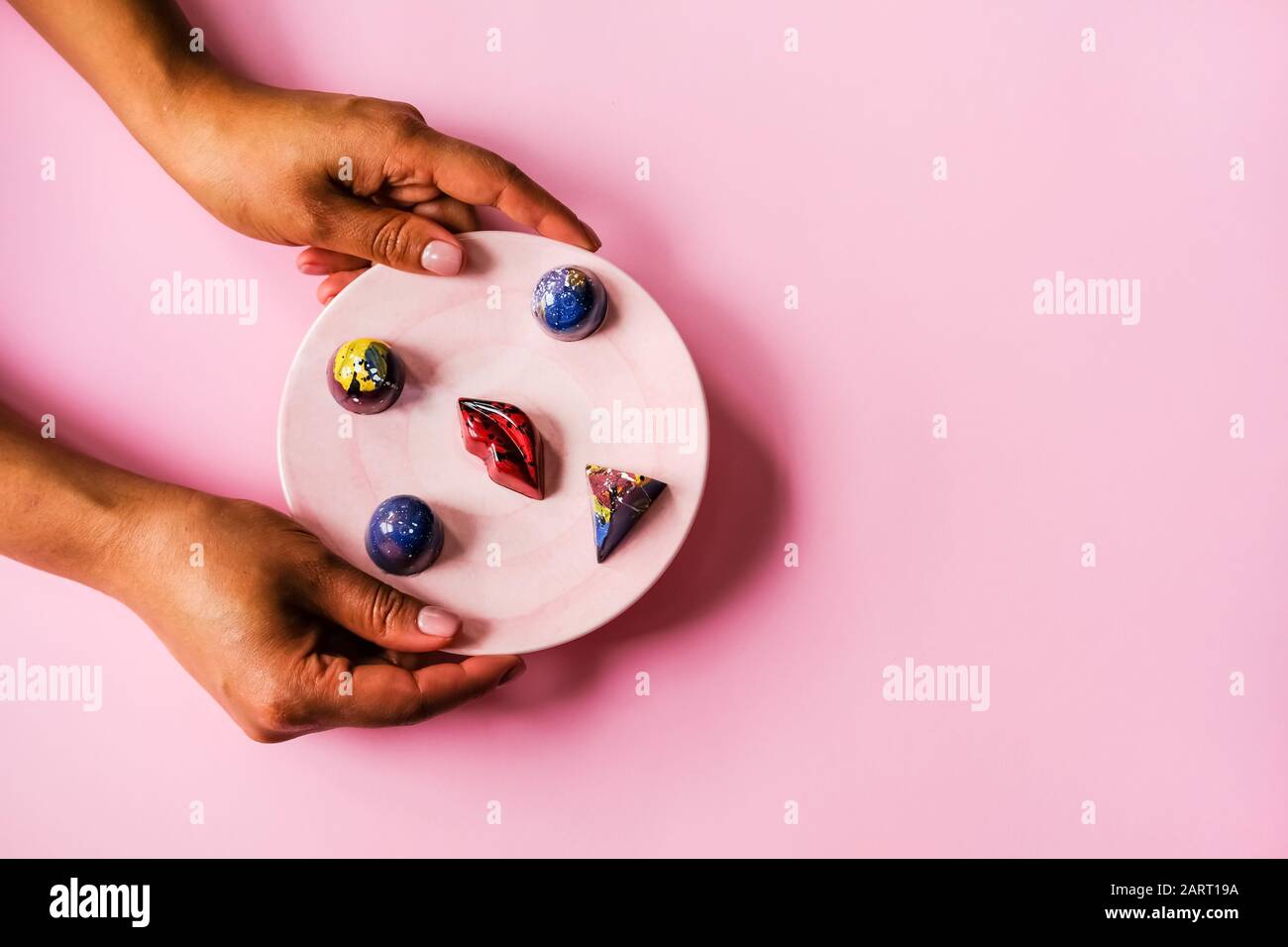 Hands and chocolates Stock Photo Alamy