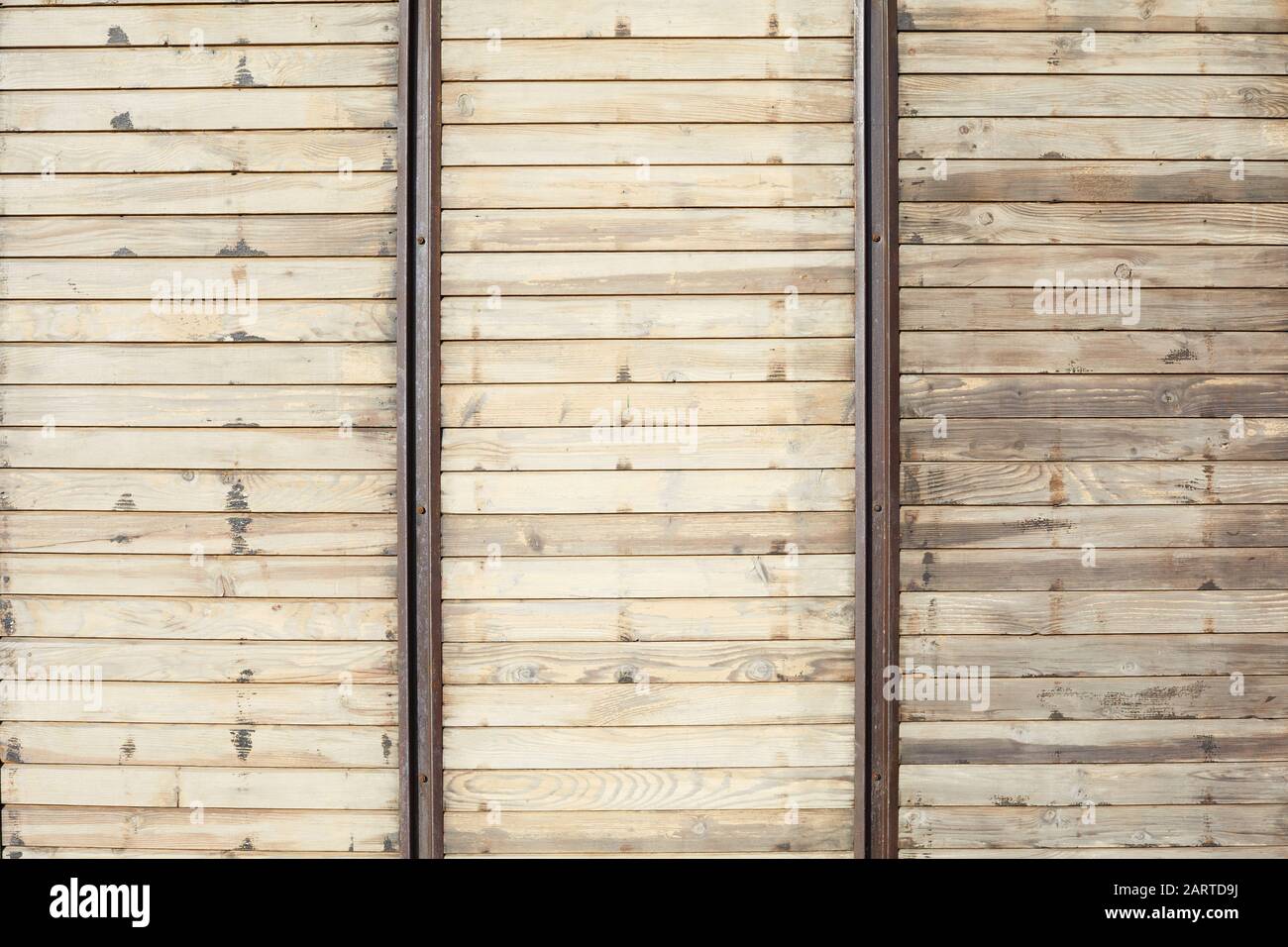 Wooden texture background with horizontal planks and vertical metal bars in sunlight Stock Photo