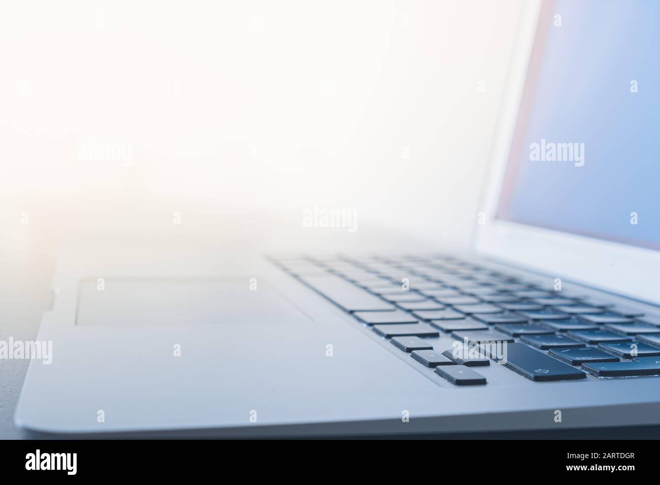 Surface of a portable computer against the bright light. Concept of well lit and bright workplace, using computer at daylight Stock Photo