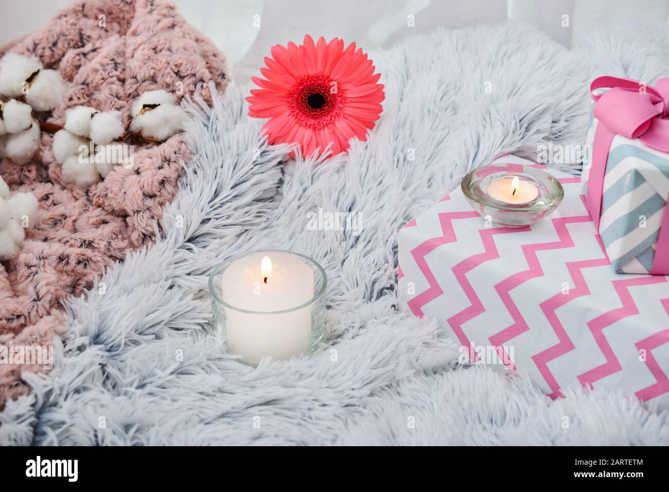 Beautiful burning candles with gift boxes on plaid Stock Photo Alamy
