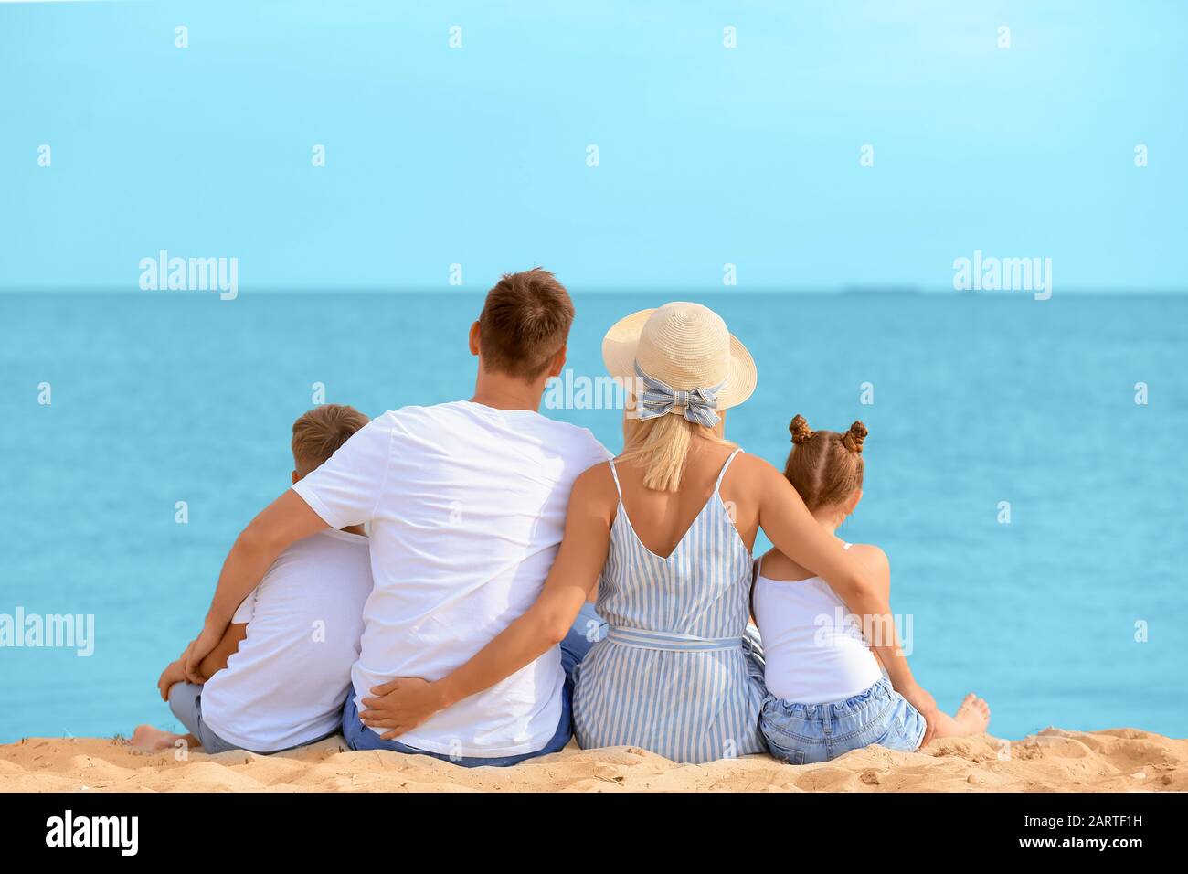 Happy family sitting at the beach hi-res stock photography and images ...