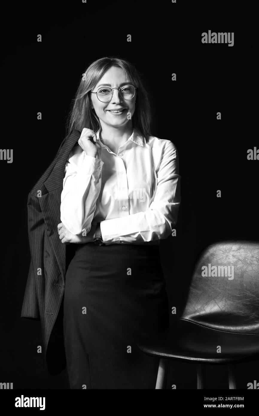 Black and white portrait of stylish businesswoman on dark background ...