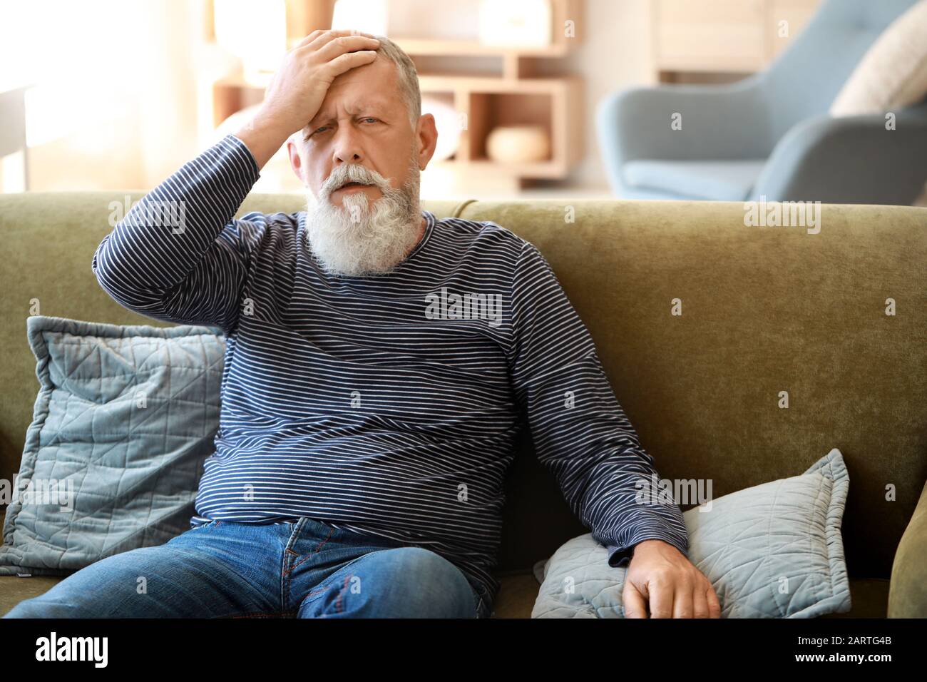 Senior man suffering from headache at home Stock Photo - Alamy