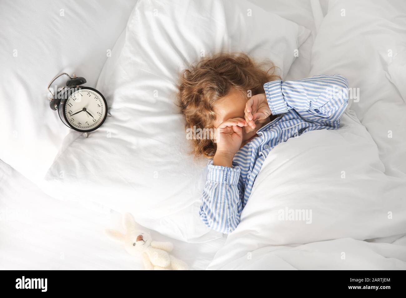 Morning of cute little girl in bed Stock Photo