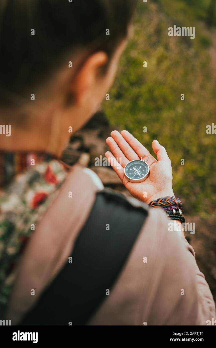 Women check direction at the compass in her hand to find right hiking path Stock Photo Alamy