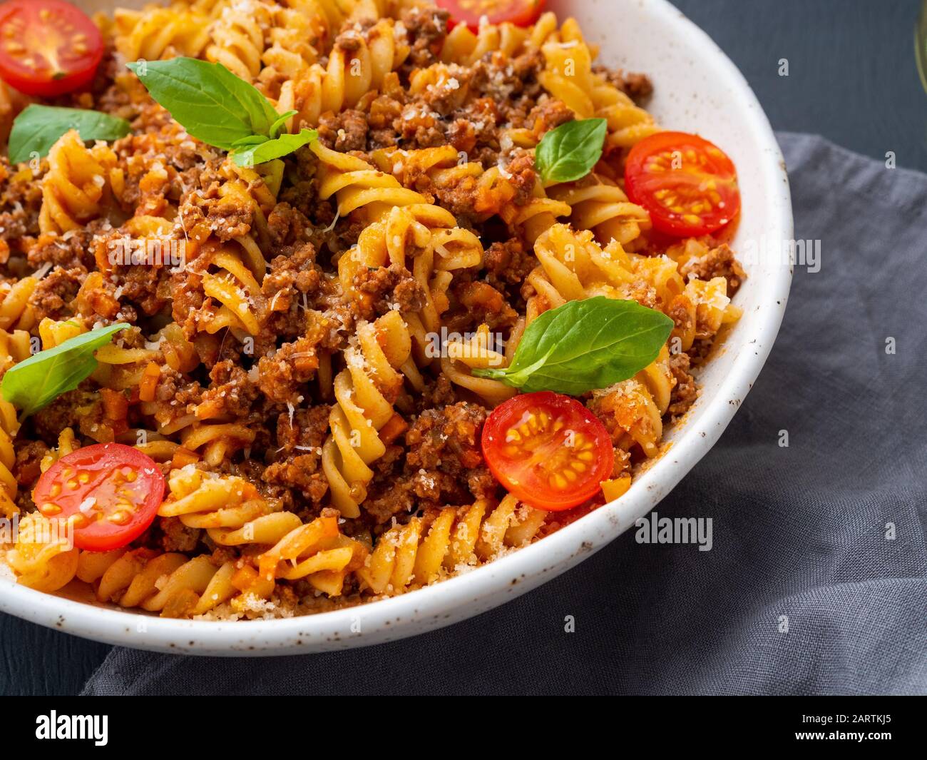 Bolognese pasta. Fusilli with tomato sauce, ground minced beef, basil