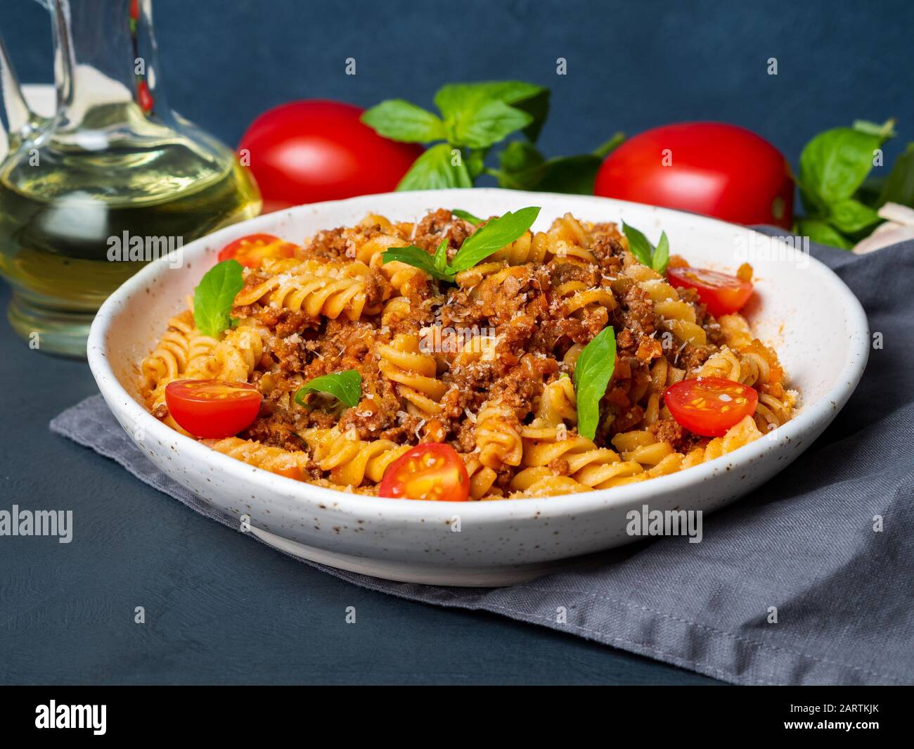 Bolognese pasta. Fusilli with tomato sauce, ground minced beef, basil