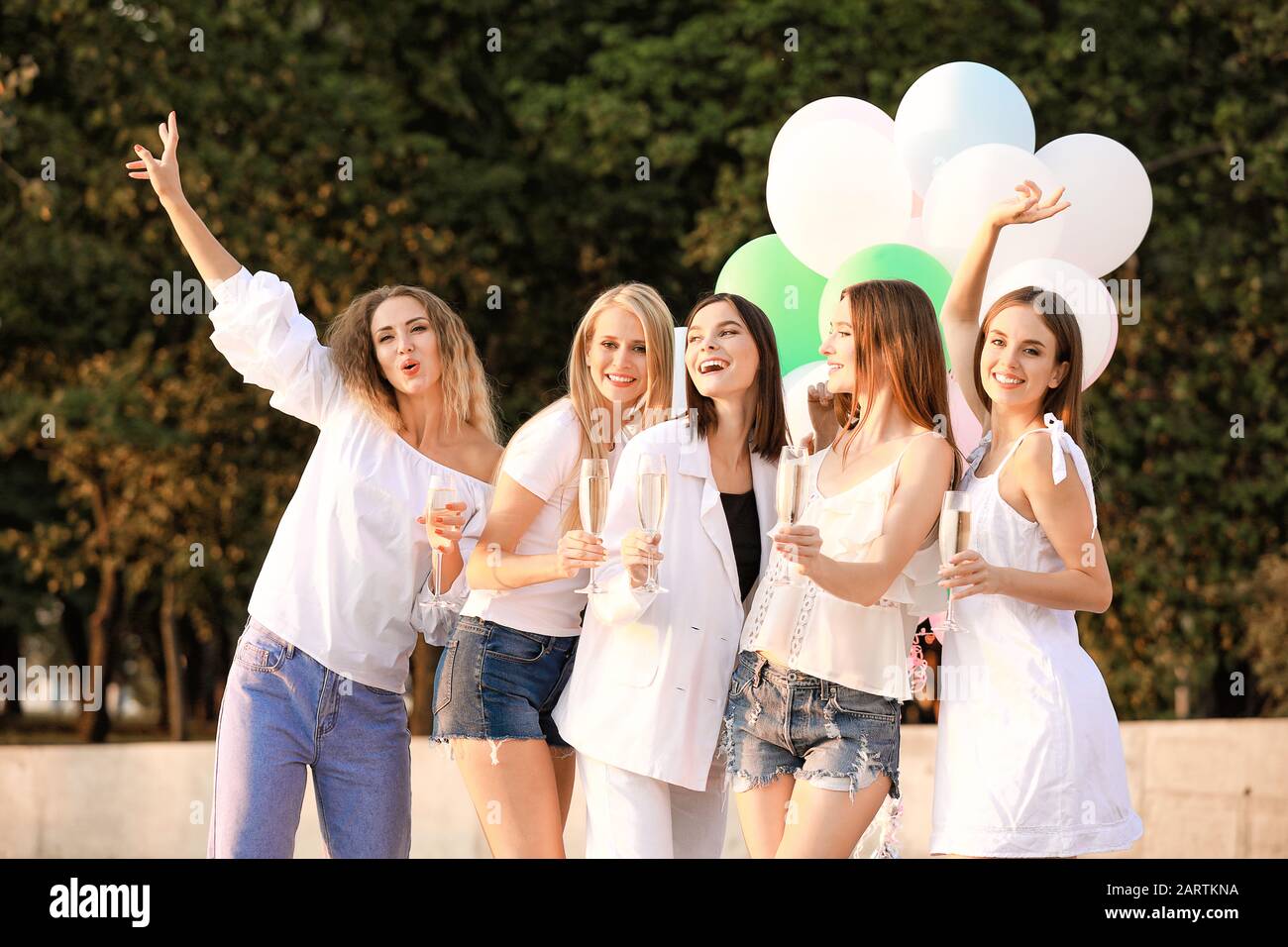 Beautiful young women with champagne at hen party outdoors Stock Photo