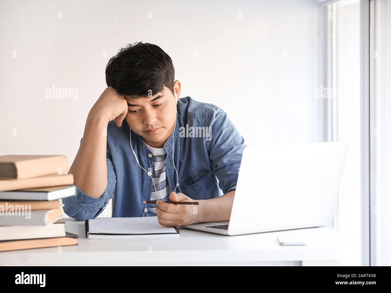 Asian student preparing for exam at home Stock Photo