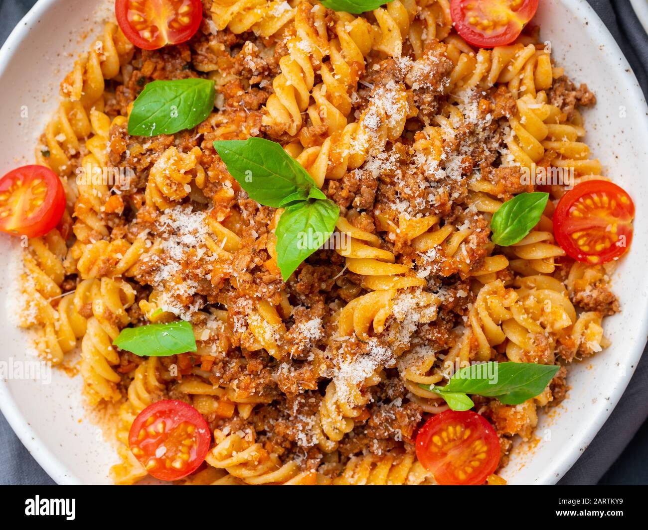 Bolognese pasta. Fusilli with tomato sauce, ground minced beef, basil