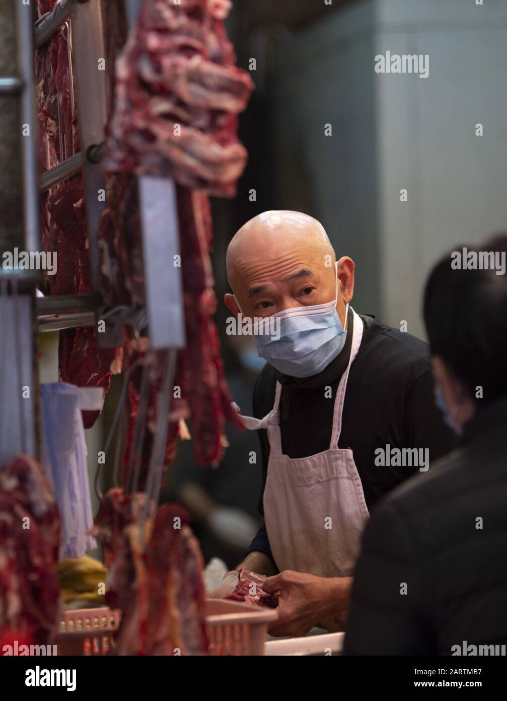 January 29, 2020, Hong Kong, Hong Kong SAR, China: A market worker wears a surgical mask as he does business. Fear of the Coronavirus from Wuhan China is evident on the streets of Hong Kong. North point markets are still busy. (Credit Image: © Jayne Russell/ZUMA Wire) Stock Photo