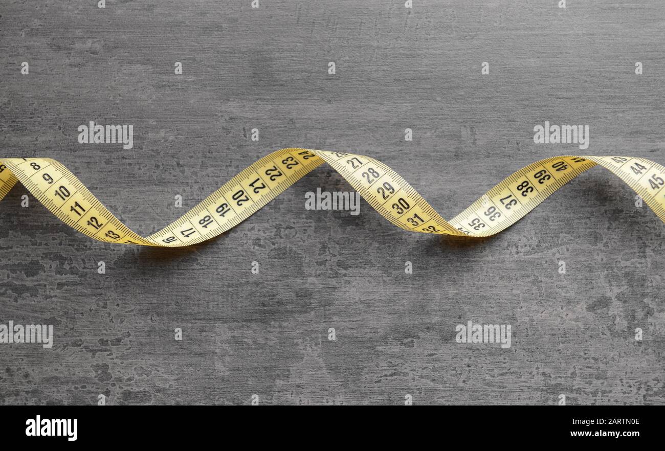 Measuring tape on grey background Stock Photo Alamy