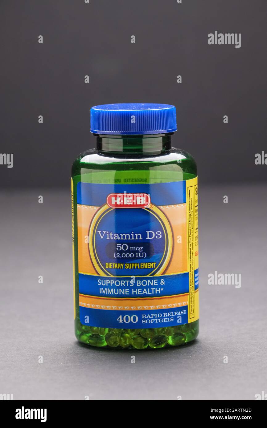 Plastic bottle of vitamin D3 supplement on dark background Stock Photo