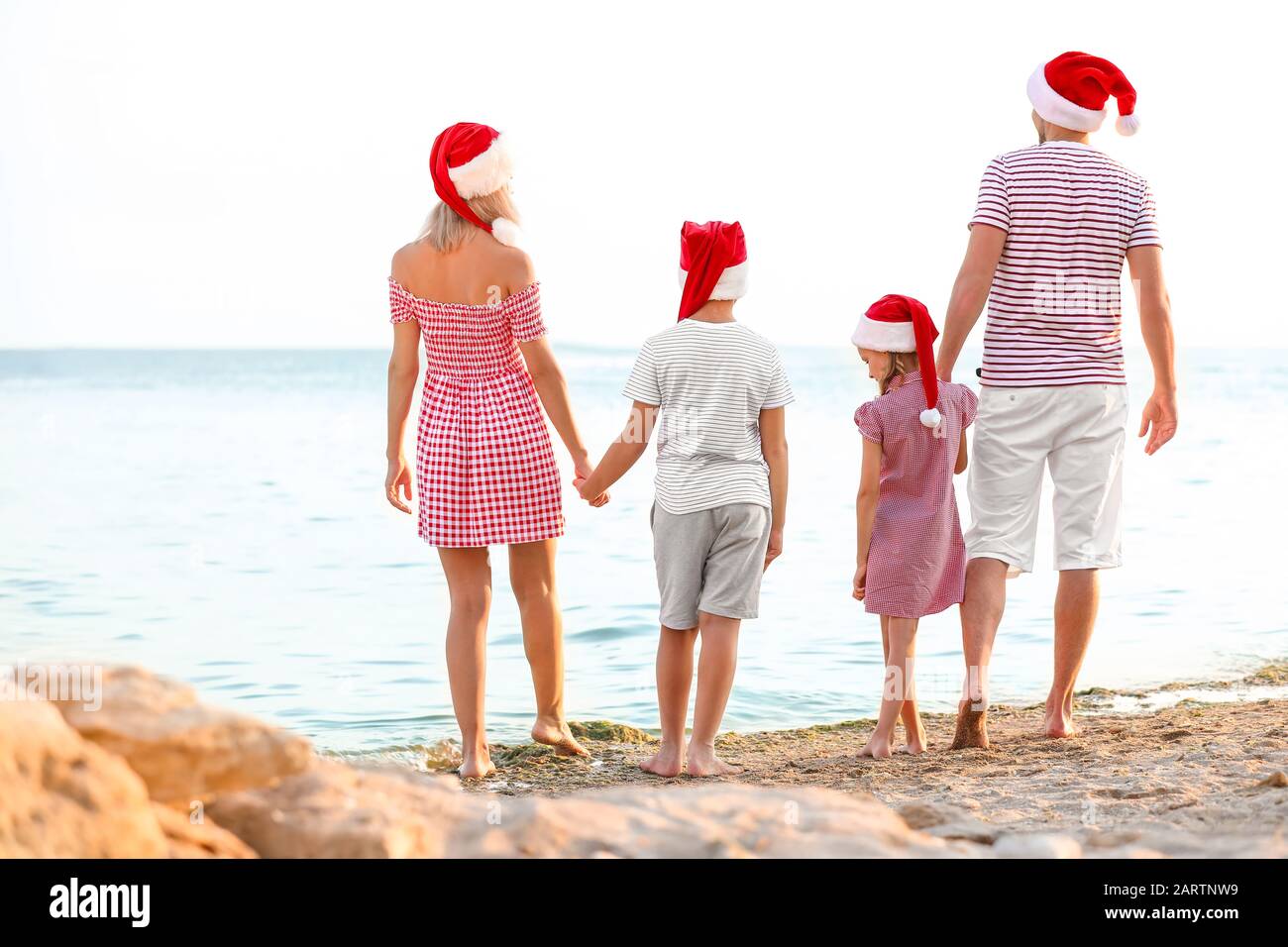 Happy family celebrating Christmas at tropical resort Stock Photo Alamy