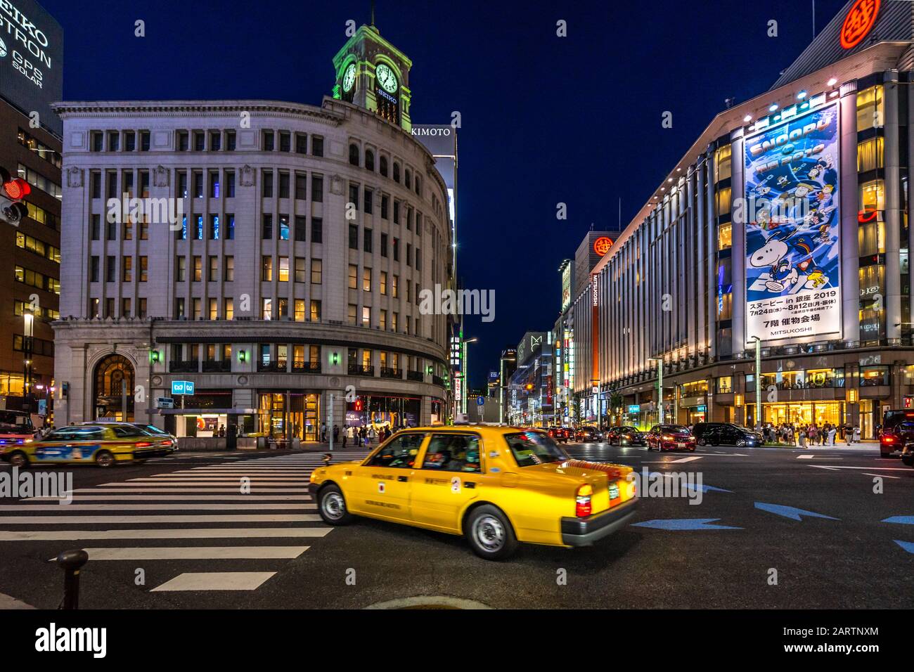 Tokyo, Japan, August 2019 – A yellow taxi in front of Ginza Wako department store Stock Photo
