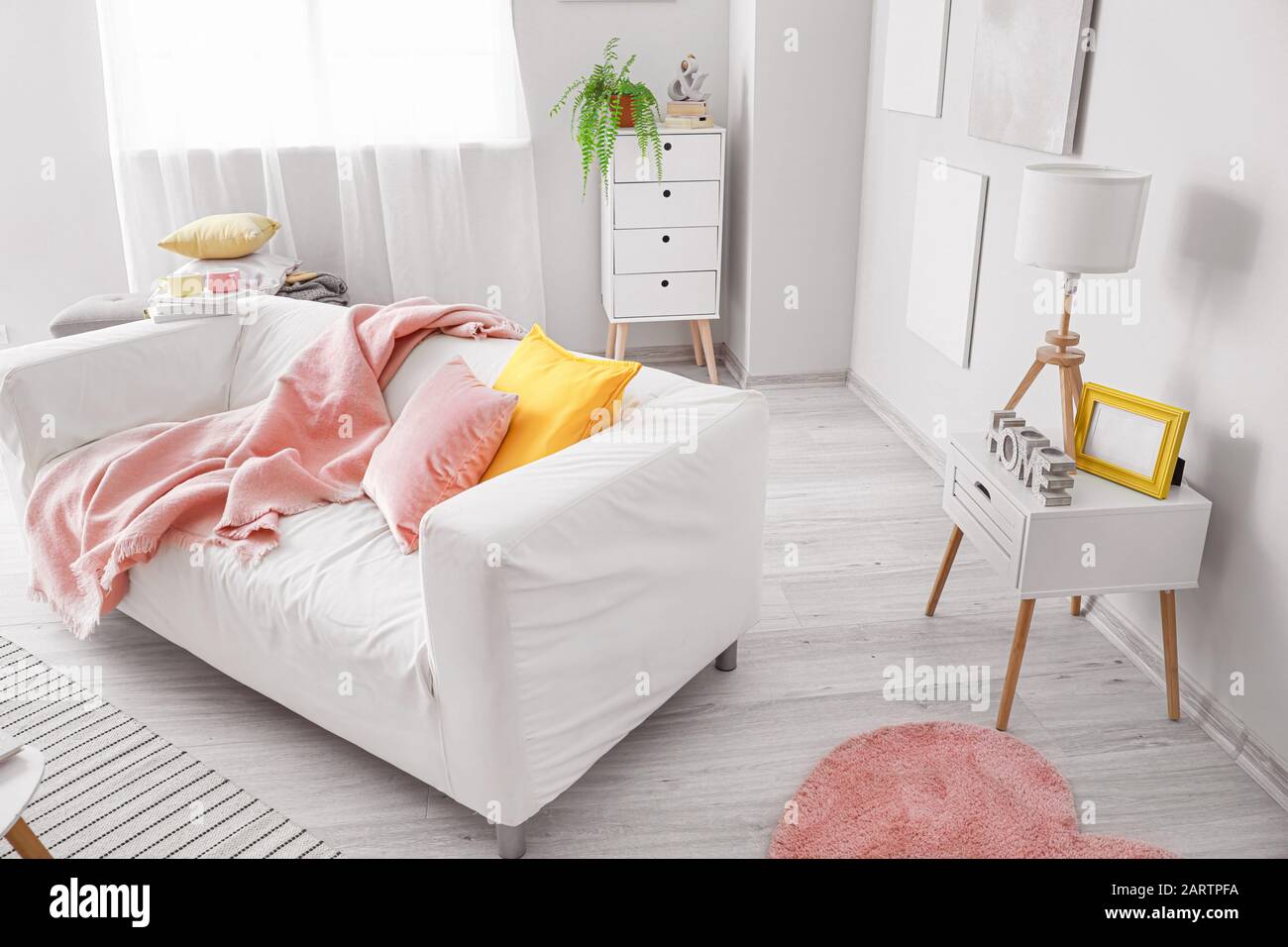 Stylish interior of living room with comfortable sofa Stock Photo - Alamy