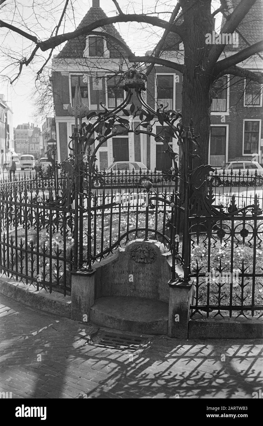 City views Leeuwarden: the Wilhelminaboom on the Raadhuisplein with ornamental fence and inscription Annotation: 1898 the current linden was planted, fitted with a large circular wrought iron fence. On the piedestal of the gate is under the lion mask the text: In Memory of the Ascension of H.M. Queen Wilhelmina Date: 8 April 1969 Location: Friesland, Leeuwarden Keywords: trees, memorials, history, fences, iron, monarchy, city sculptures, succession to the throne. Personal name: Wilhelmina (queen Netherlands) Stock Photo