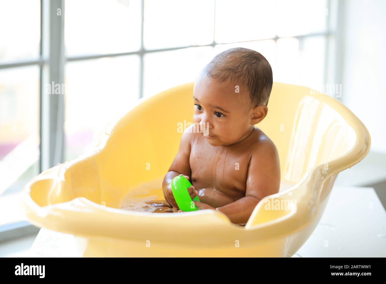 Little AfricanAmerican baby washing in bathtub at home Stock Photo Alamy