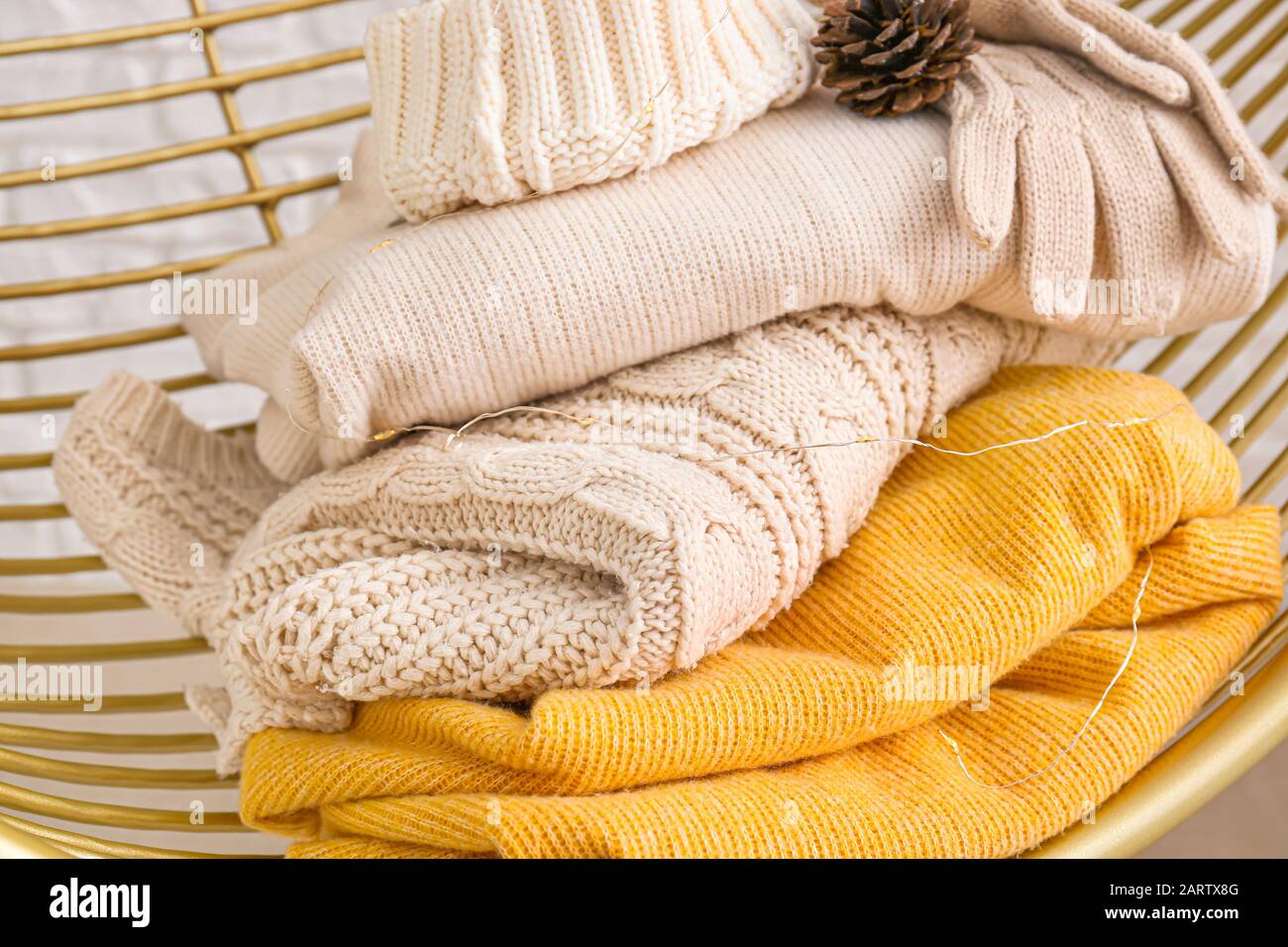 Winter clothes in armchair, closeup Stock Photo