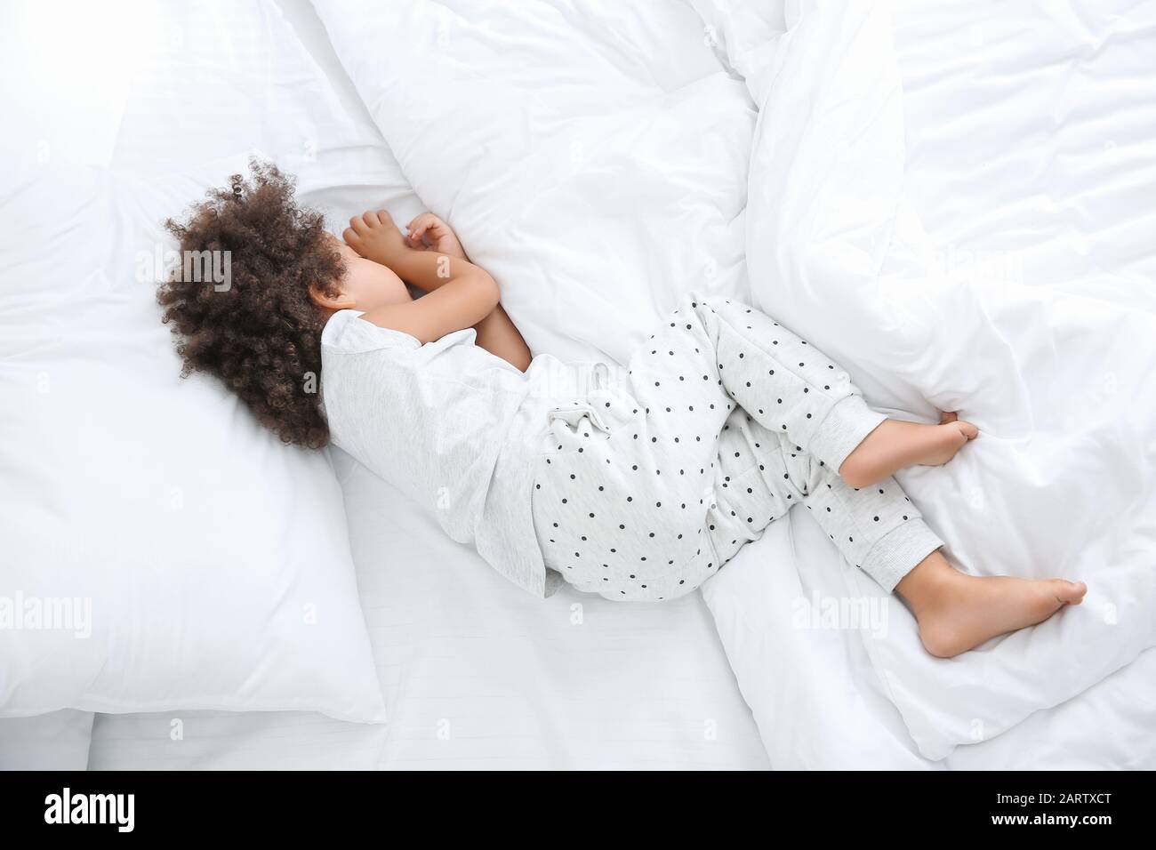 Little African-American girl sleeping in bed Stock Photo - Alamy