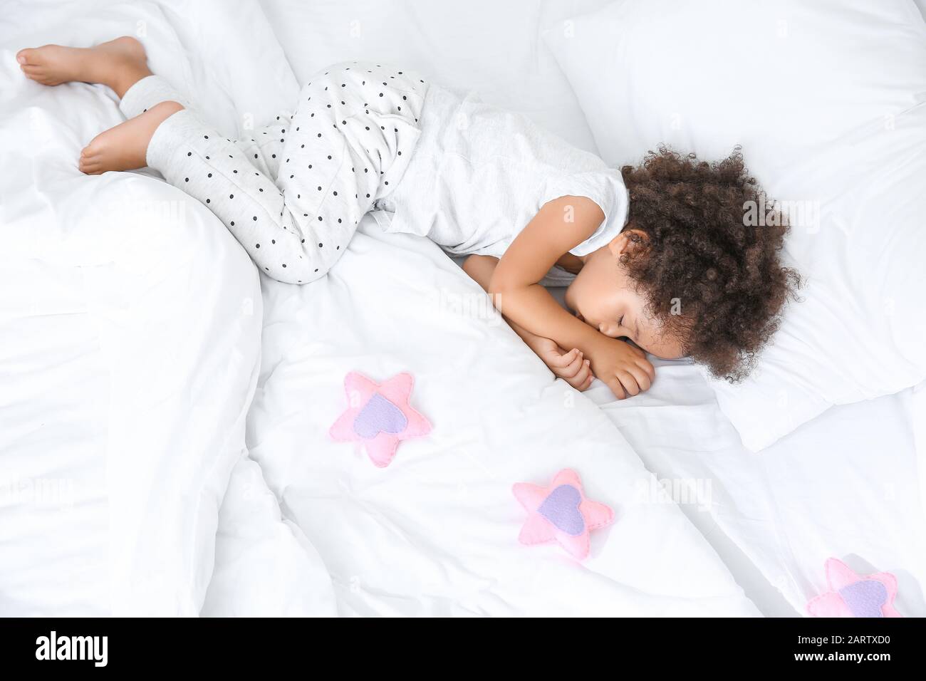 Little African-American girl sleeping in bed Stock Photo - Alamy