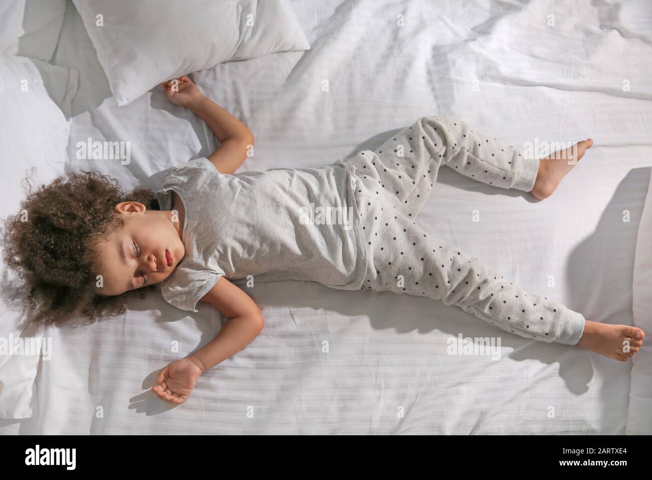 Little AfricanAmerican girl sleeping in bed at night Stock Photo Alamy