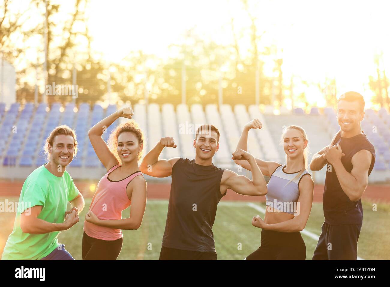 Group of sporty young people at the stadium Stock Photo - Alamy