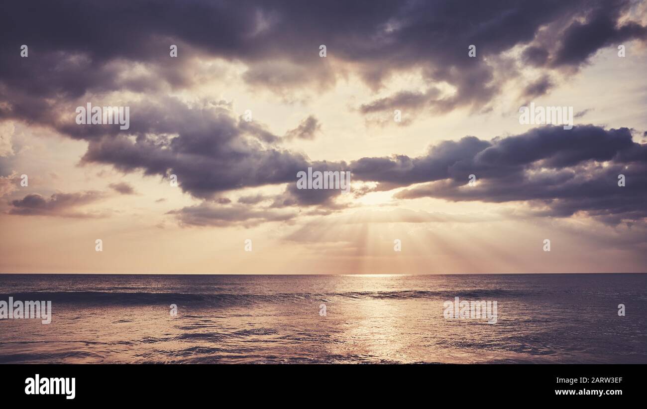 Scenic sunset over the water, color toning applied. Stock Photo