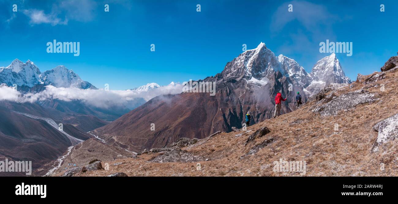 Panoramic view of backpackers facing to Tabuche Peak from the way to Nangkar Tshang View Point, Dingboche, Sagarmatha national park, Everest Base Camp Stock Photo