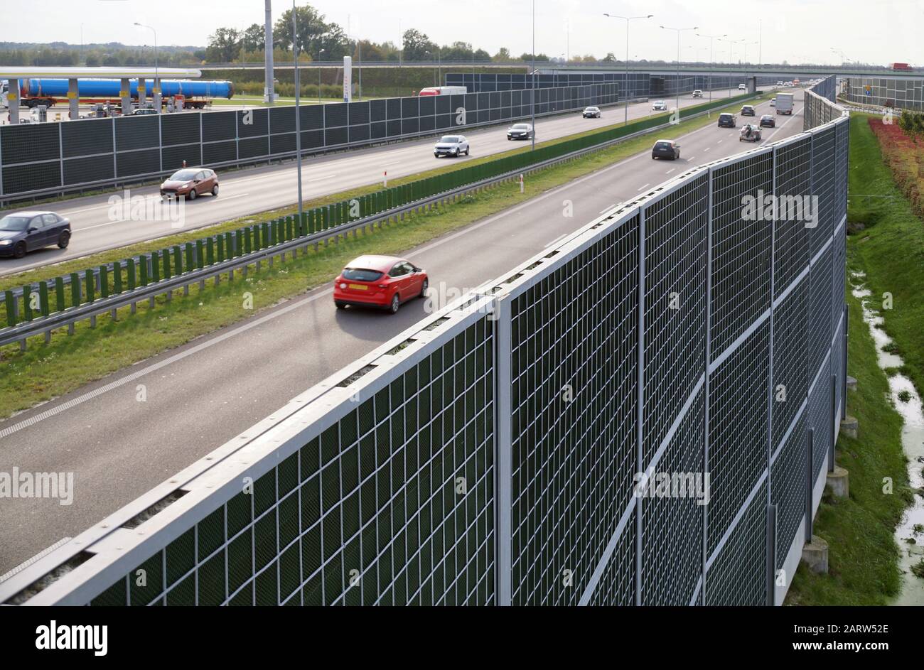 High soundabsorbing barriers separating the highway from the