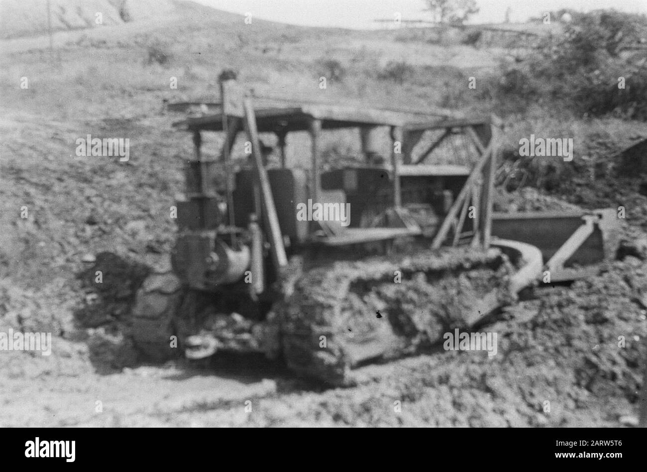 Coal Mines Moeara Enim (Palembangs)  Coal mining in the Boekit Asem Mines. The coal layers are on the surface and can therefore be easily excavated. Bulldozer Date: 10 October 1947 Location: Indonesia, Dutch East Indies, Palembangs, Sumatra Stock Photo