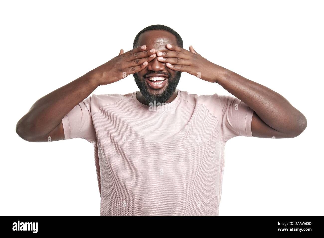 Handsome African-American man covering his eyes on white background ...