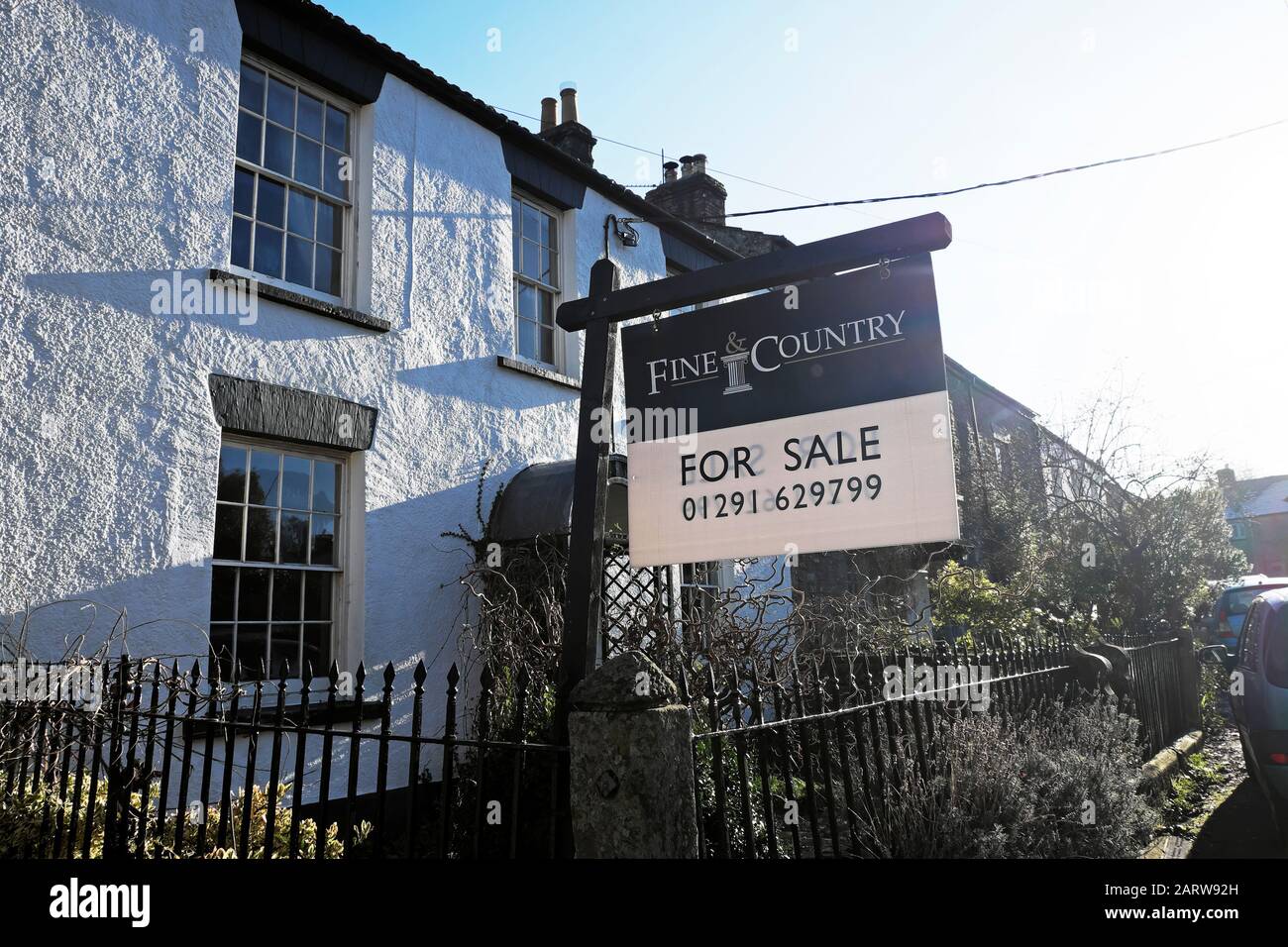 House for sale sign outside a traditional stone cottage property in St Briavels village