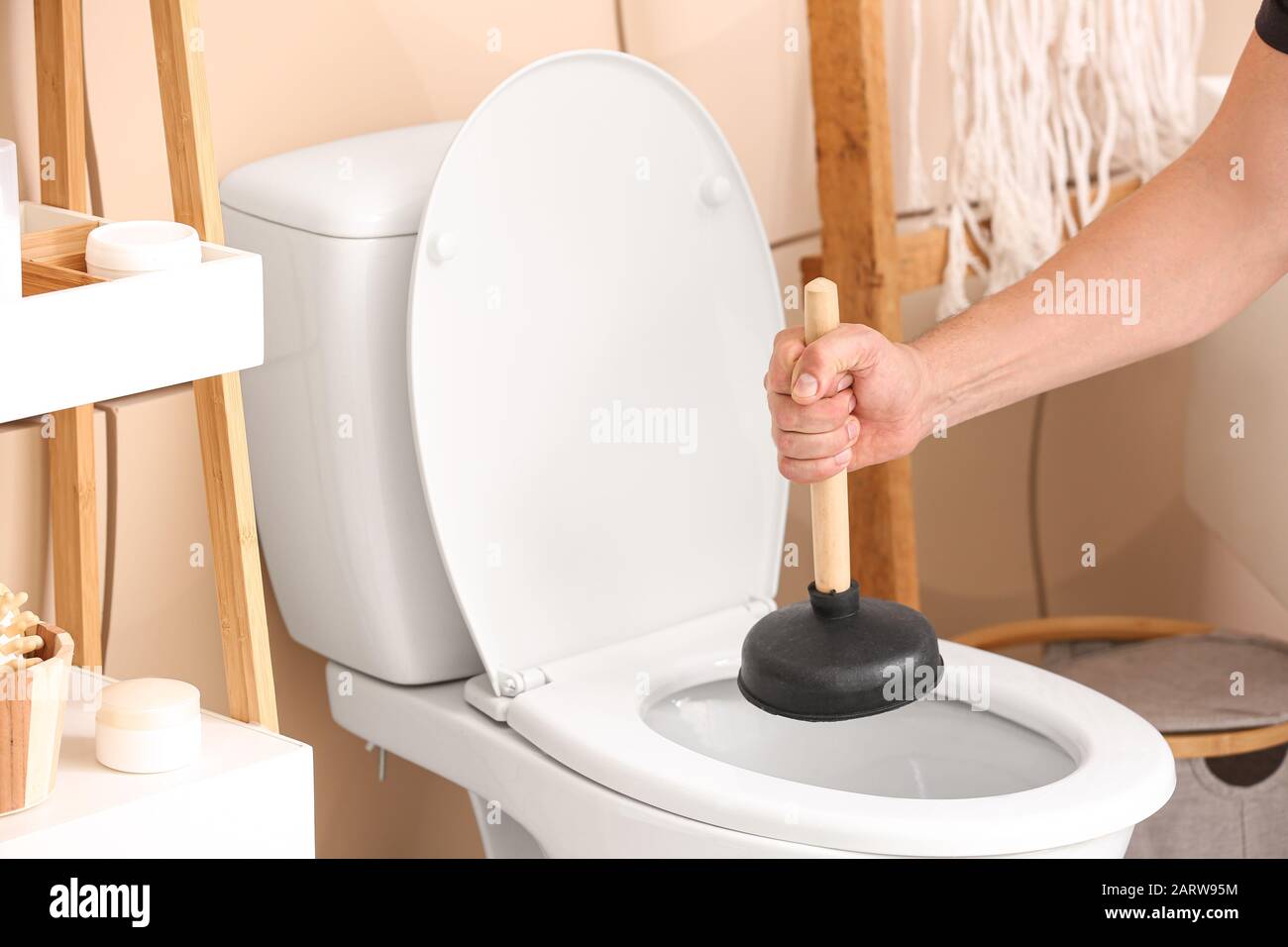 Man Using a Plunger to unstop his kitchen sink 4773754 Stock Photo at  Vecteezy
