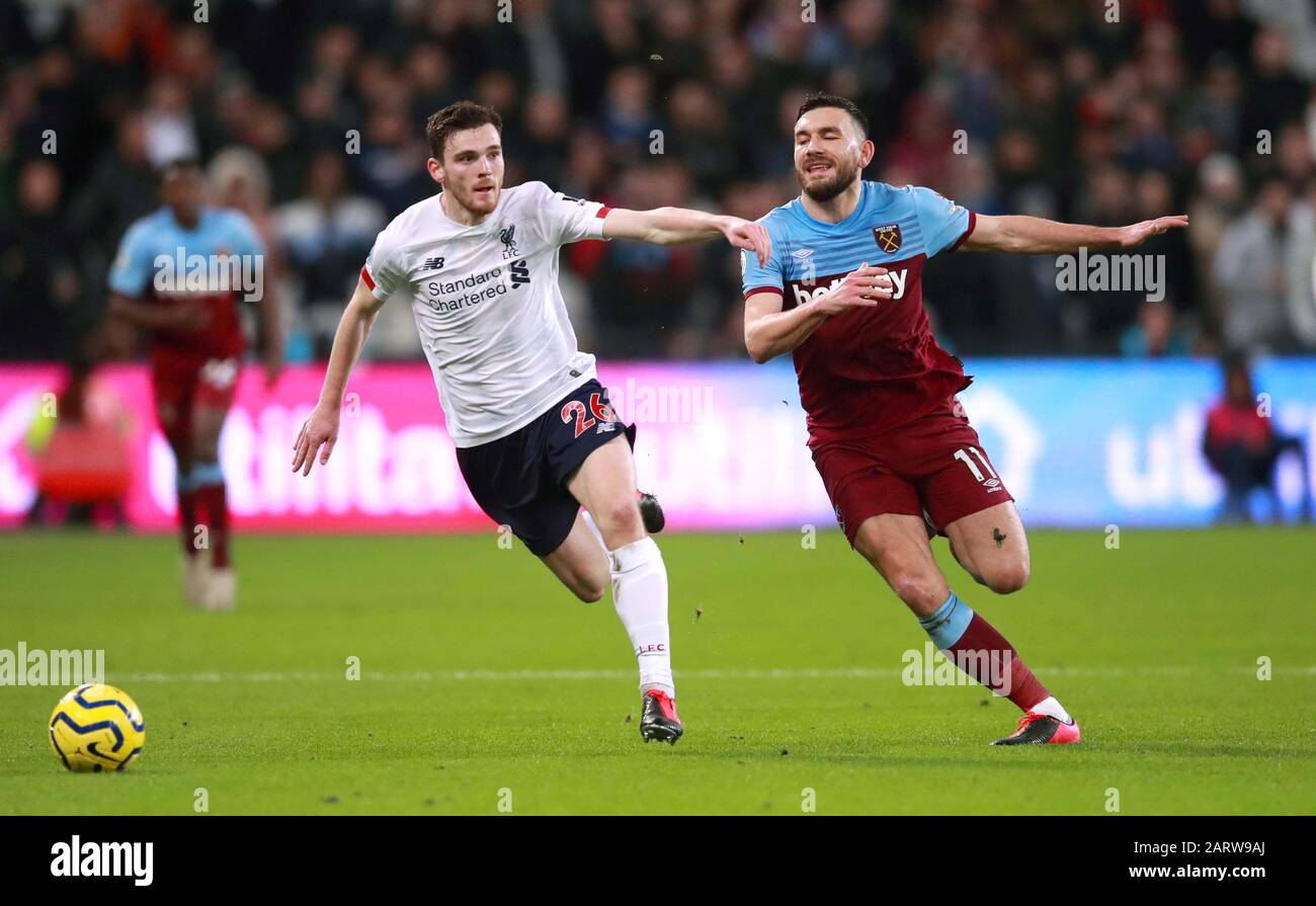 Liverpool's Andrew Robertson (left) and West Ham United's Robert Snodgrass battle for the ball during the Premier League match at London Stadium. Stock Photo